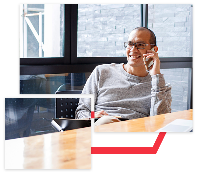 Young business owner on phone in office